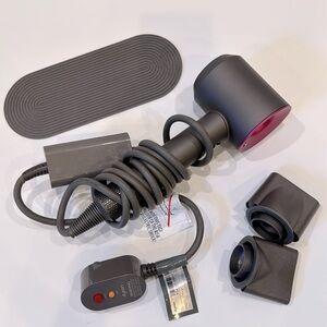 Dyson supersonic hair dryer with attachments and rest/heat pad